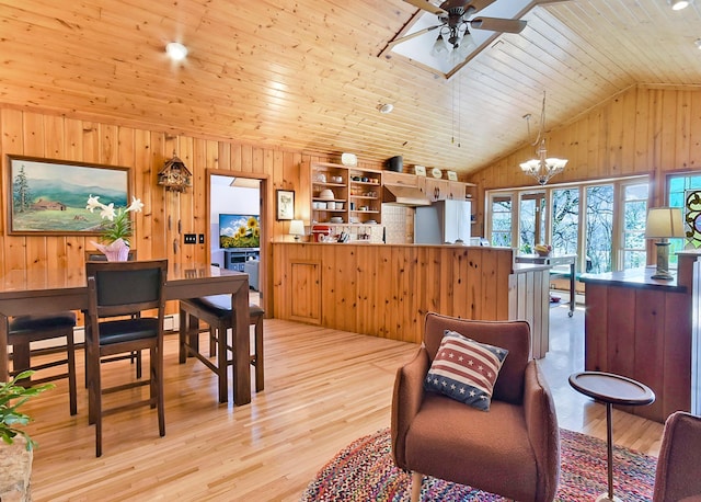 6575 145th St E, Cannon City Twp, MN 55057 - interior space with wood ceiling, ceiling fan with notable chandelier, wooden walls, light wood-style floors, and vaulted ceiling with skylight