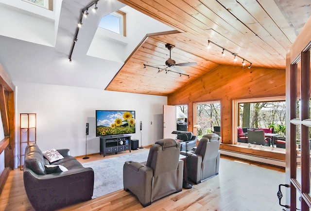 6575 145th St E, Cannon City Twp, MN 55057 - living room with track lighting, wood walls, lofted ceiling, and a baseboard heating unit