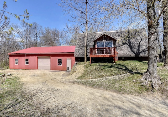 6575 145th St E, Cannon City Twp, MN 55057 - exterior space featuring driveway, an outbuilding, metal roof, and a deck