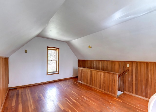 6575 145th St E, Cannon City Twp, MN 55057 - additional living space featuring vaulted ceiling, wooden walls, baseboards, and light wood-type flooring
