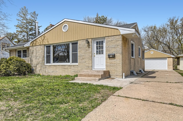 bungalow-style home featuring a garage, an outdoor structure, a front lawn, brick siding, and concrete driveway