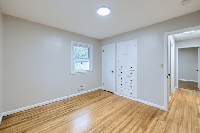 unfurnished bedroom featuring light wood-style flooring and baseboards