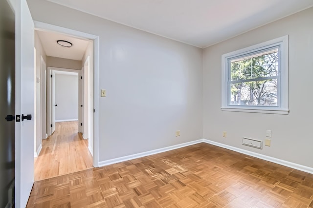 spare room featuring baseboards