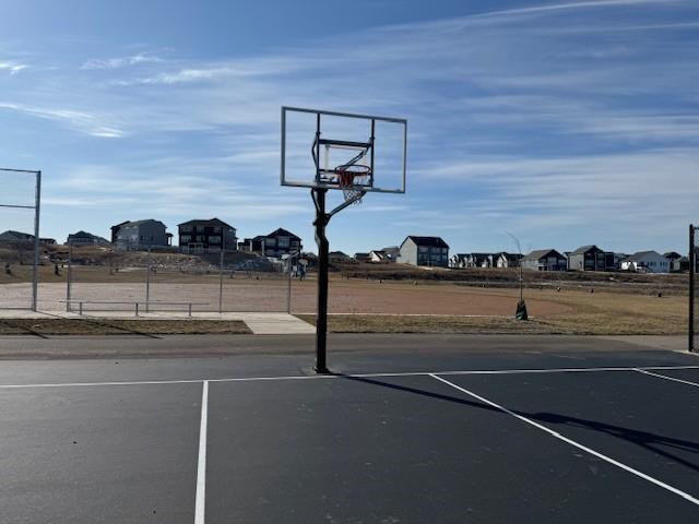 view of basketball court with community basketball court and a residential view
