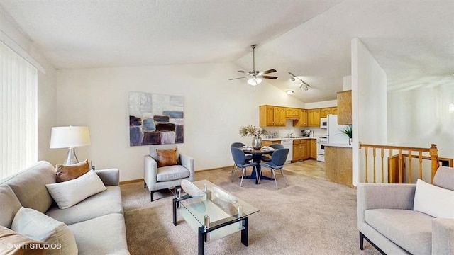 living area with baseboards, ceiling fan, lofted ceiling, and light carpet