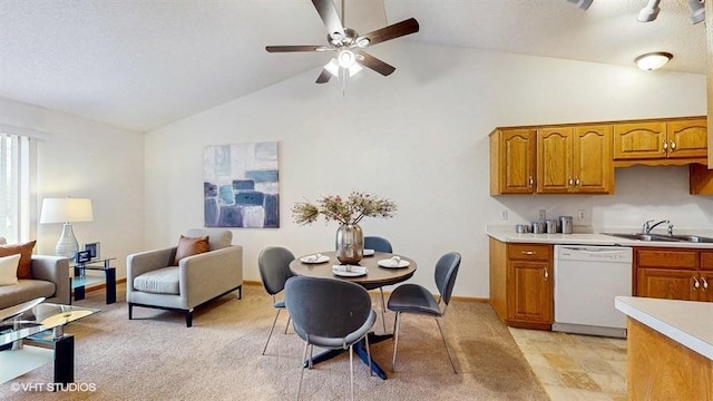 kitchen with white dishwasher, a sink, light countertops, brown cabinetry, and lofted ceiling
