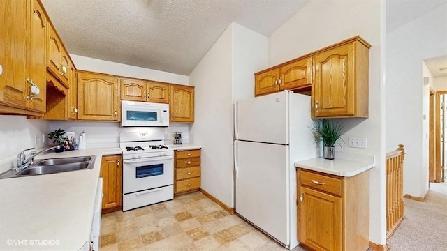 kitchen featuring lofted ceiling, white appliances, light countertops, brown cabinets, and a sink