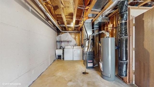 unfinished below grade area with washer and clothes dryer, a sink, and gas water heater