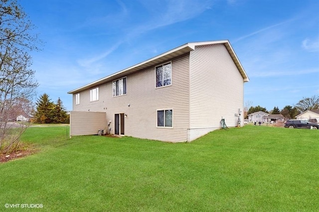back of property with a lawn