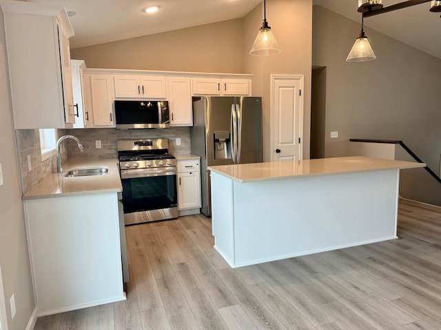 kitchen featuring light countertops, a sink, white cabinets, and stainless steel appliances