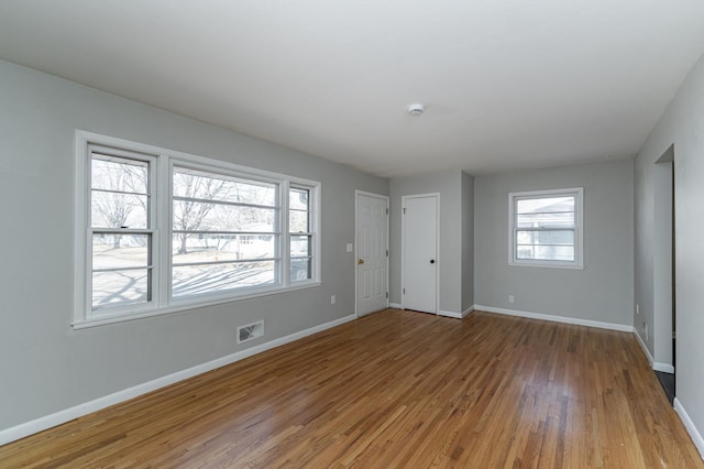 unfurnished bedroom featuring light wood-style floors and baseboards