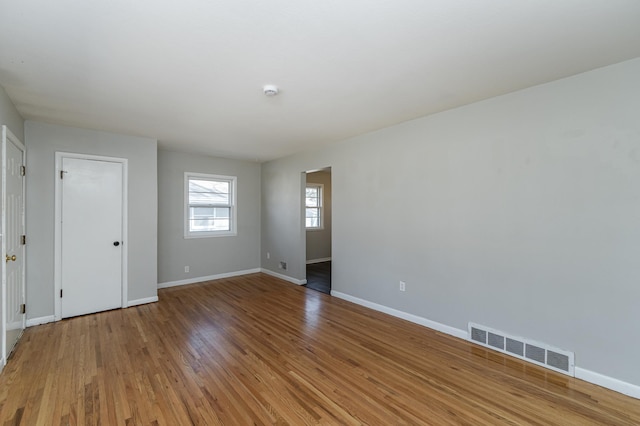unfurnished room with baseboards and light wood finished floors