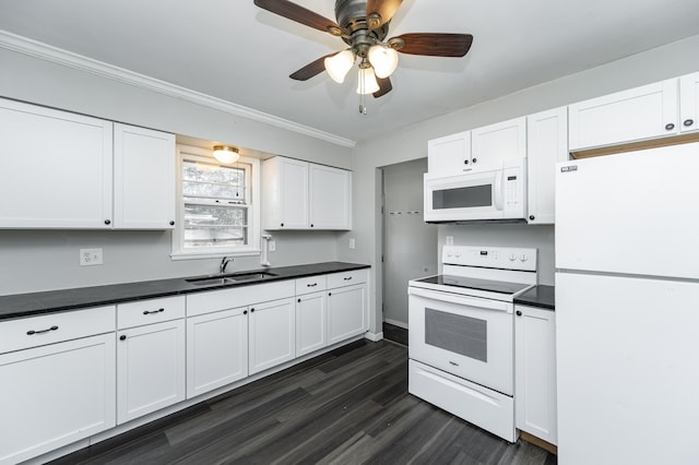 kitchen featuring white appliances, a sink, dark countertops, ceiling fan, and dark wood-style floors