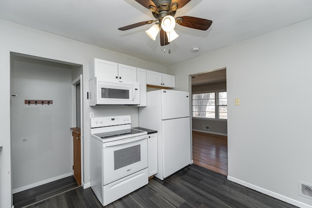 kitchen with white appliances, dark wood-style flooring, baseboards, and white cabinets