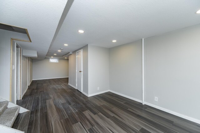 finished below grade area with wood finished floors, recessed lighting, baseboards, and stairway