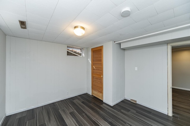 finished below grade area featuring dark wood-type flooring and baseboards