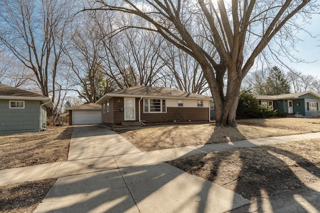 single story home with an outbuilding and a detached garage