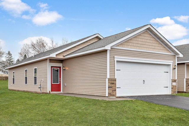 501 Redwood St N, Cambridge, MN 55008 - ranch-style house featuring a garage, a front lawn, aphalt driveway, stone siding, and roof with shingles
