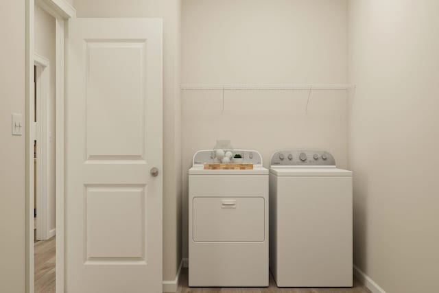 501 Redwood St N, Cambridge, MN 55008 - laundry area with separate washer and dryer, laundry area, baseboards, and light wood-type flooring
