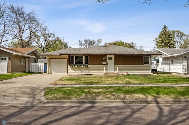 221 26th Ave N, Fargo, ND 58102 - ranch-style house featuring driveway, an attached garage, entry steps, a shingled roof, and board and batten siding