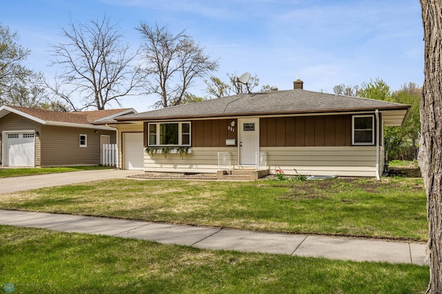 221 26th Ave N, Fargo, ND 58102 - ranch-style house with a garage, a chimney, driveway, a front yard, and a shingled roof