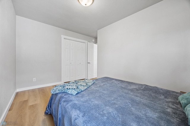 221 26th Ave N, Fargo, ND 58102 - bedroom featuring wood finished floors, a closet, and baseboards