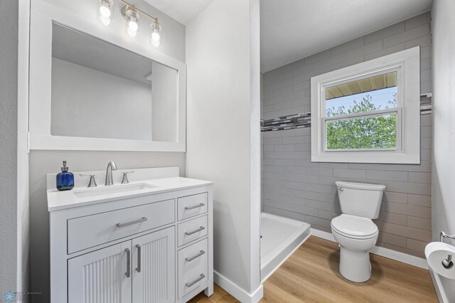 221 26th Ave N, Fargo, ND 58102 - full bath with toilet, wood finished floors, a shower stall, vanity, and baseboards
