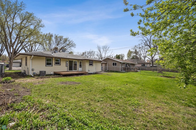 221 26th Ave N, Fargo, ND 58102 - back of property featuring a wooden deck, cooling unit, and a chimney
