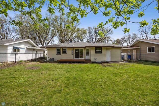 221 26th Ave N, Fargo, ND 58102 - back of property featuring a wooden deck, central AC, and a chimney