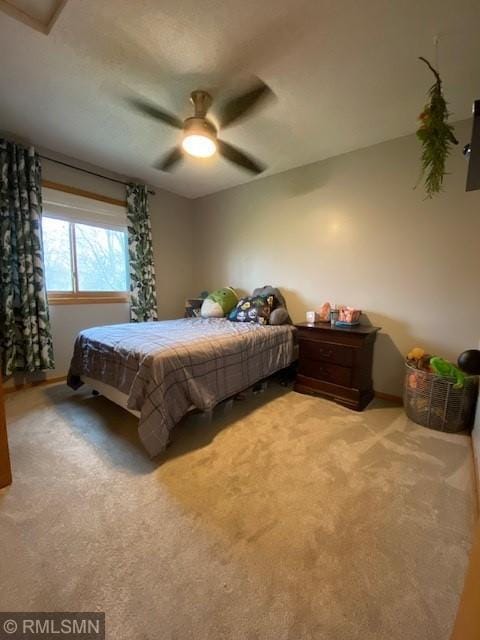 bedroom featuring a ceiling fan and carpet