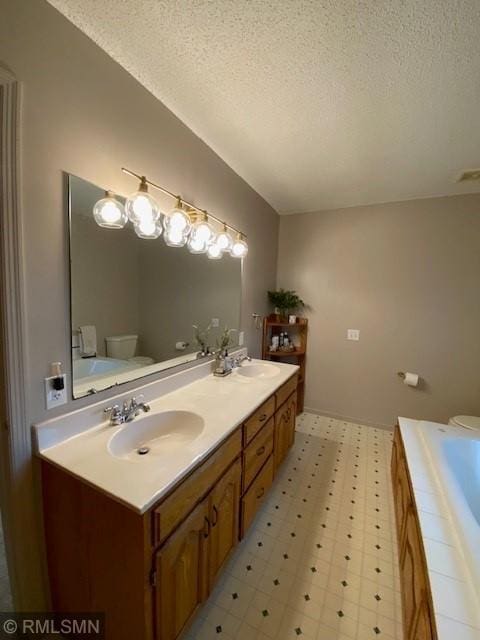 full bathroom featuring double vanity, a sink, and a textured ceiling
