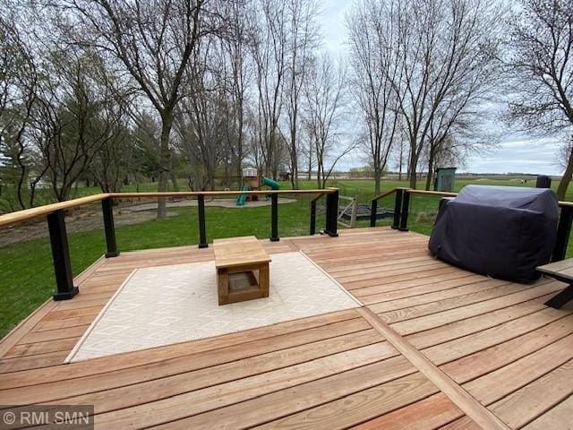 deck with a playground, a yard, and area for grilling