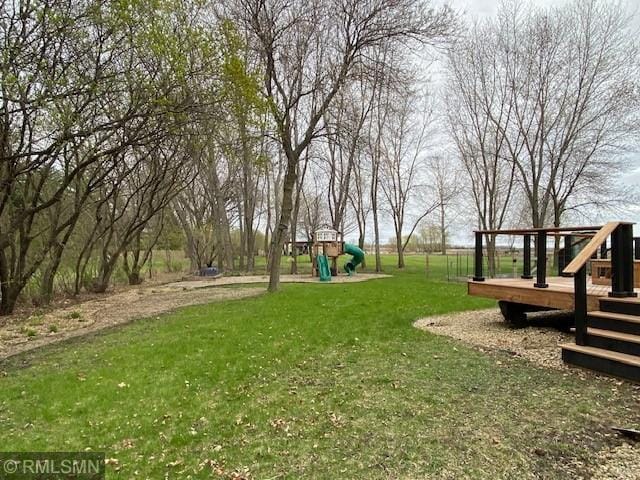 view of yard featuring a playground and a wooden deck