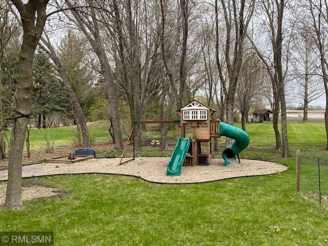 community jungle gym with a lawn