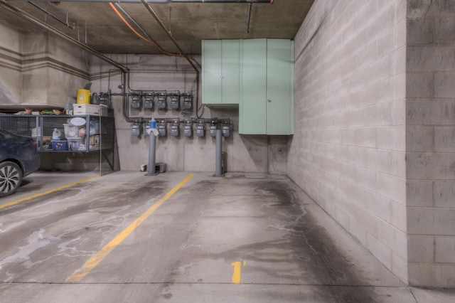 parking garage featuring concrete block wall