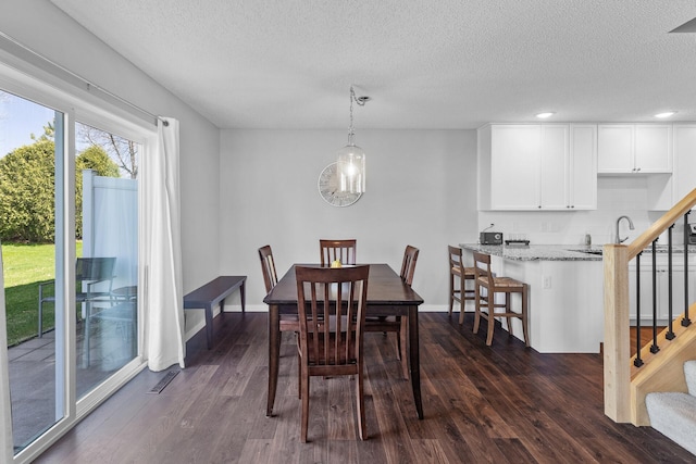 dining room featuring dark wood finished floors, a textured ceiling, stairway, recessed lighting, and baseboards