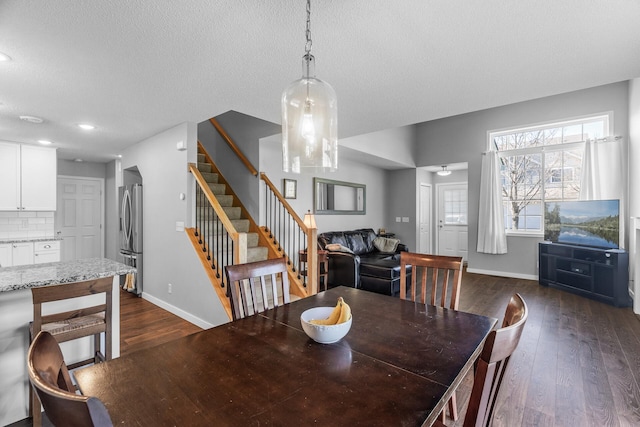 dining area featuring stairs, dark wood finished floors, baseboards, recessed lighting, and a textured ceiling