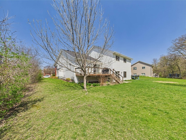 2200 Orchid Dr NE, Sauk Rapids, MN 56379 - rear view of house with a lawn, stairway, and a wooden deck