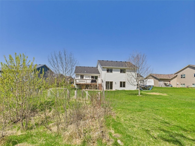 2200 Orchid Dr NE, Sauk Rapids, MN 56379 - back of house featuring a deck and a lawn