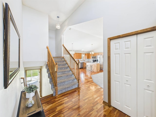 2200 Orchid Dr NE, Sauk Rapids, MN 56379 - stairs with wood finished floors and high vaulted ceiling