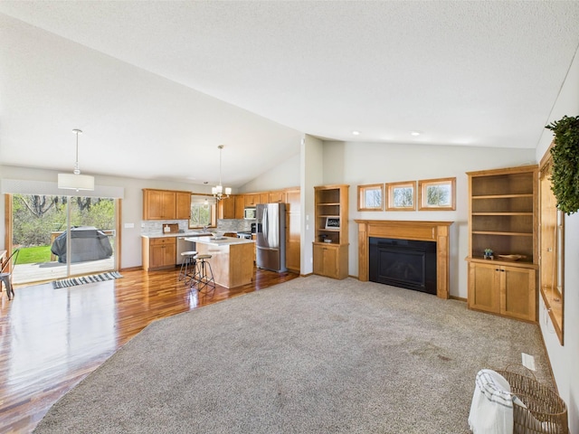 2200 Orchid Dr NE, Sauk Rapids, MN 56379 - living area featuring a fireplace, high vaulted ceiling, light wood-style flooring, and a chandelier