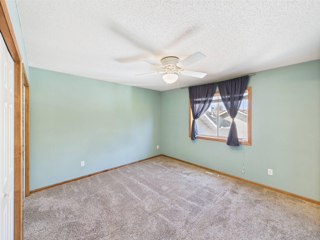 2200 Orchid Dr NE, Sauk Rapids, MN 56379 - carpeted empty room featuring a ceiling fan, baseboards, visible vents, and a textured ceiling