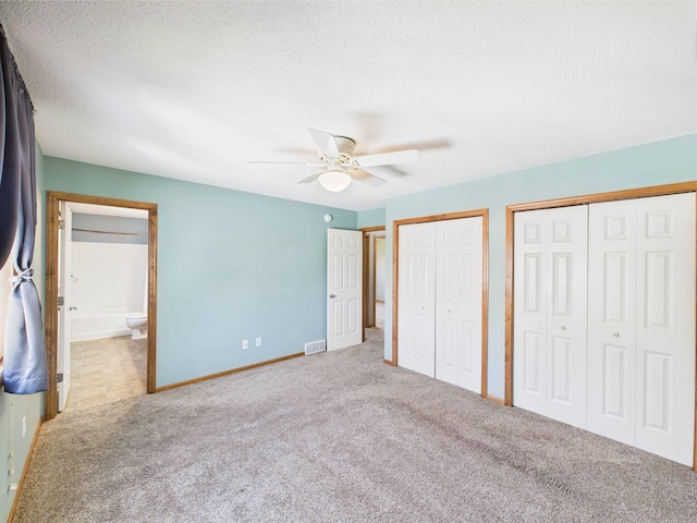 2200 Orchid Dr NE, Sauk Rapids, MN 56379 - unfurnished bedroom featuring two closets, carpet floors, baseboards, and visible vents