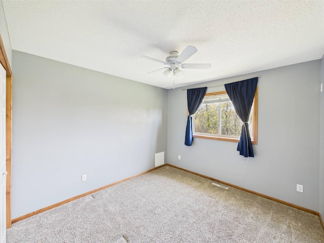 2200 Orchid Dr NE, Sauk Rapids, MN 56379 - carpeted empty room featuring a textured ceiling, visible vents, baseboards, and ceiling fan