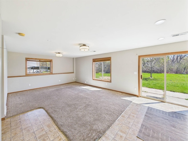 2200 Orchid Dr NE, Sauk Rapids, MN 56379 - spare room with baseboards, light carpet, visible vents, and light tile patterned flooring