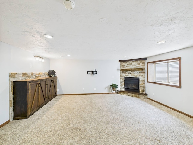 2200 Orchid Dr NE, Sauk Rapids, MN 56379 - unfurnished living room featuring baseboards, a stone fireplace, carpet flooring, and recessed lighting