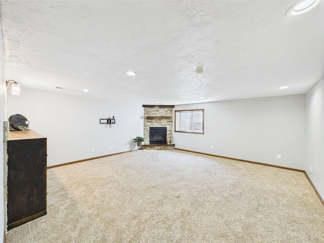 2200 Orchid Dr NE, Sauk Rapids, MN 56379 - unfurnished living room with carpet floors, a stone fireplace, baseboards, and recessed lighting