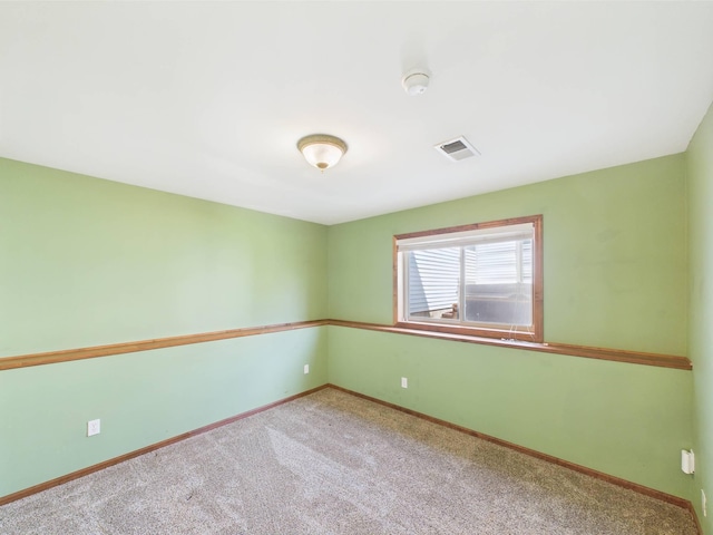 2200 Orchid Dr NE, Sauk Rapids, MN 56379 - spare room featuring carpet, baseboards, and visible vents