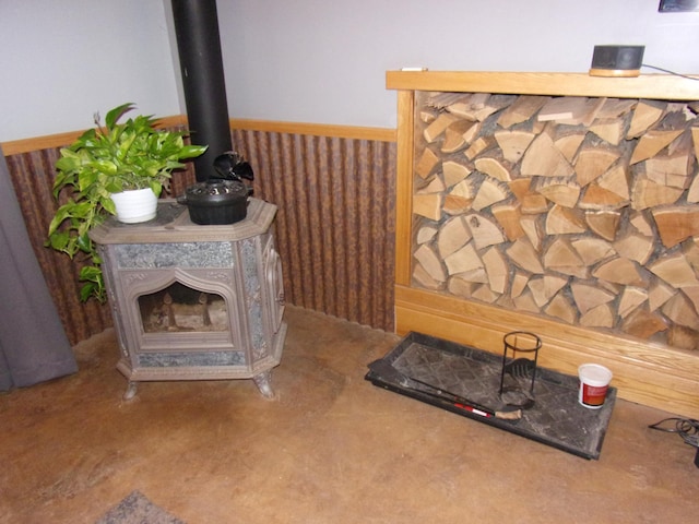 room details with a wood stove and wainscoting