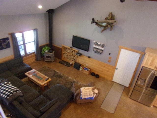 living area featuring carpet and a wood stove